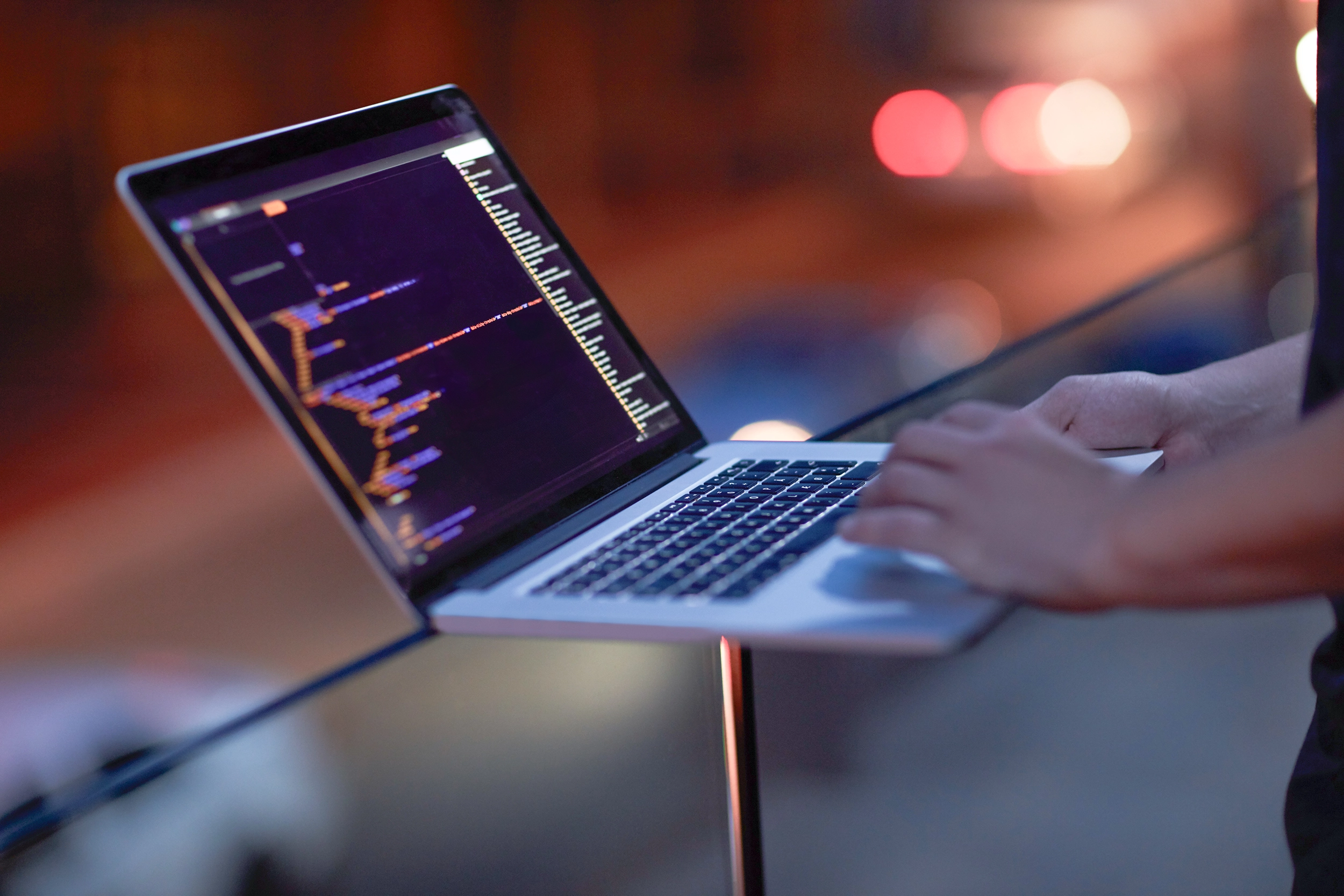 Digiten's stock image with laptop and code lines.